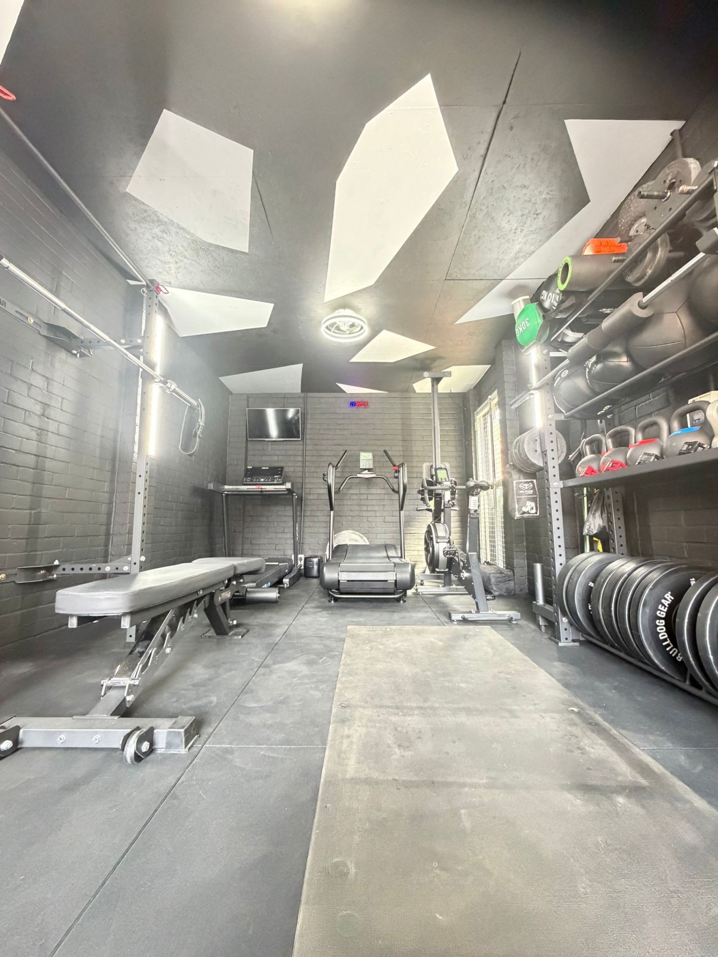 Gym entrance with sled push equipment and kettlebells